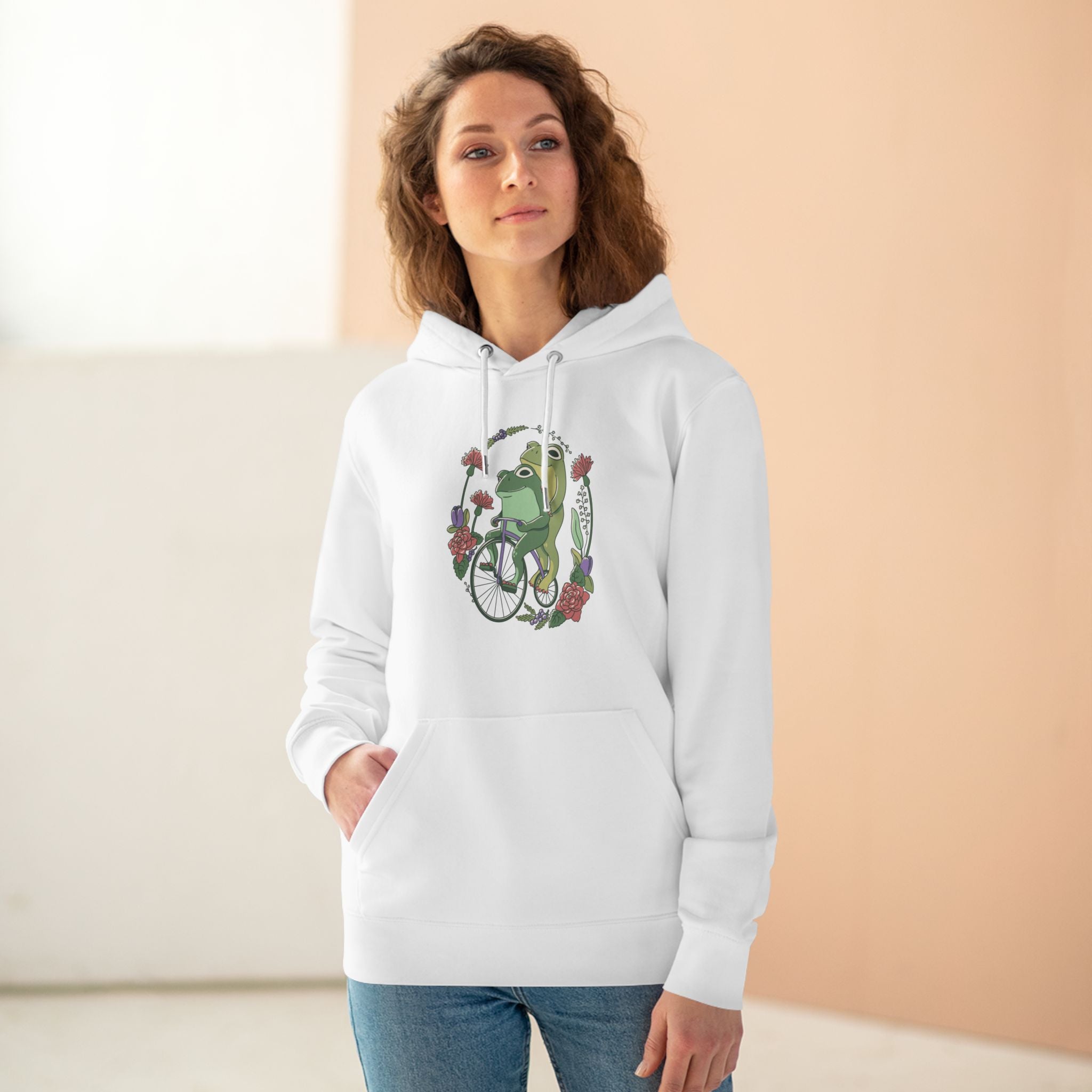 Cottagecore Unisex Hoodie Stil mit fröhlichen Fröschen auf Fahrrad